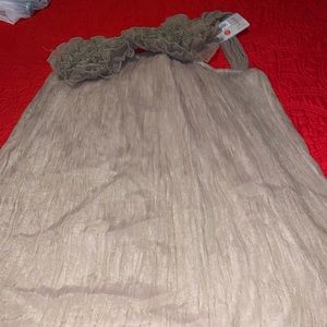 Gold shirt/dress with flower across the top.